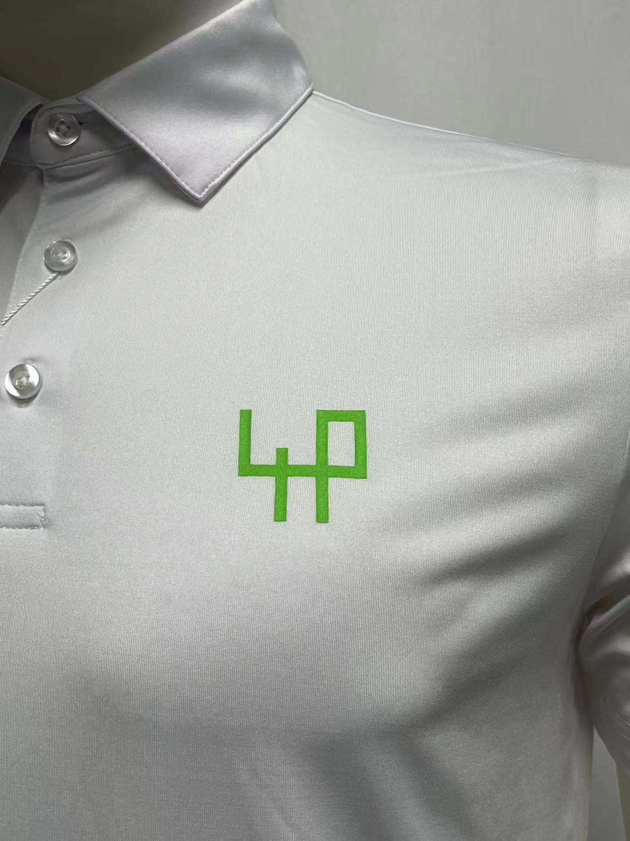 White polo Fore Player with green logo left shoulder detail front view