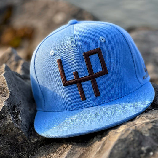 exclusive attire blue cap on rock, leman lake, switzerland
